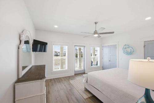 a white bedroom with a bed and a ceiling fan at Perfect location Pool 4 bedroom SGI Pet in Eastpoint