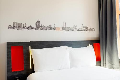 a bedroom with a bed with a city drawing on the wall at easyHotel Sheffield in Sheffield