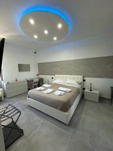 a bedroom with a large bed with a blue light at Milano Bicocca Apartment & Rooms2 in Cinisello Balsamo