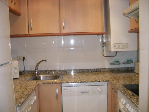 a kitchen with a sink and a counter top at Apartamentos Ball Benas Edificio Prados de Velarta in Cerler