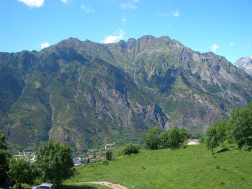 a mountain range with a car parked on a hill at Apartamentos Ball Benas Edificio Prados de Velarta in Cerler