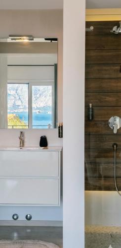 a bathroom with a sink and a mirror at Villa Morion with Sauna and Pool in Donji Morinj
