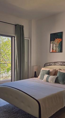 a bedroom with a large bed with a window at Villa Morion with Sauna and Pool in Donji Morinj
