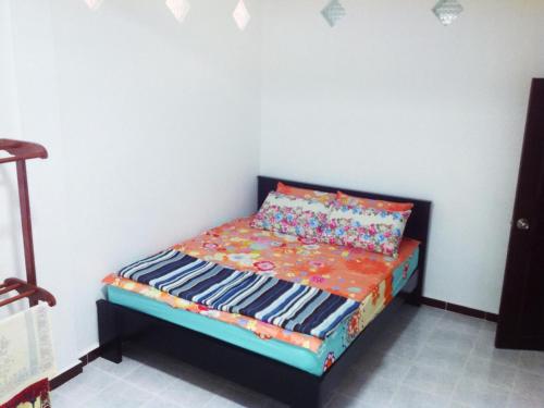 a small bed in a corner of a room at Nur Muslim 3 Homestay At Kota Bharu in Kota Bharu