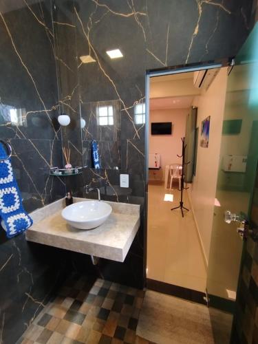 a bathroom with a sink and a shower at Pousada Consulado in Brasília