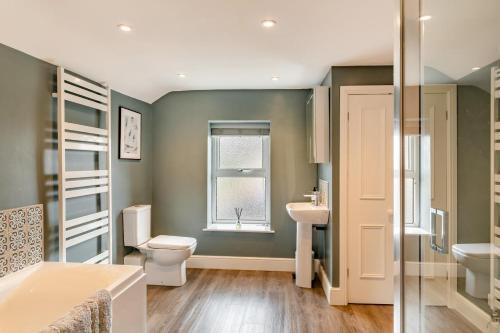 a bathroom with a toilet and a sink and a window at 4 Bed in Masham oc-w32087 in Masham