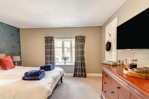 a bedroom with a large bed and a large window at 4 Bed in Masham oc-w32087 in Masham