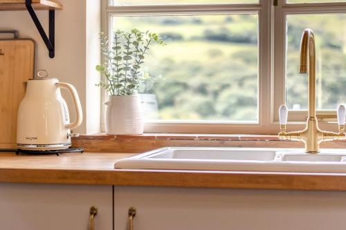 a kitchen counter with a sink and a window at 2 Bed in Cwmystwyth oc-p32779 in Pentre-briwnant