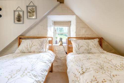 two beds in a attic room with a window at 2 Bed in Cwmystwyth oc-p32779 in Pentre-briwnant