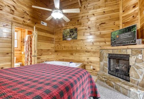 a bedroom with a bed and a fireplace at Bucky's Bungalow, Free Attraction Tickets, Hot Tub, WIFI!!! in Gatlinburg