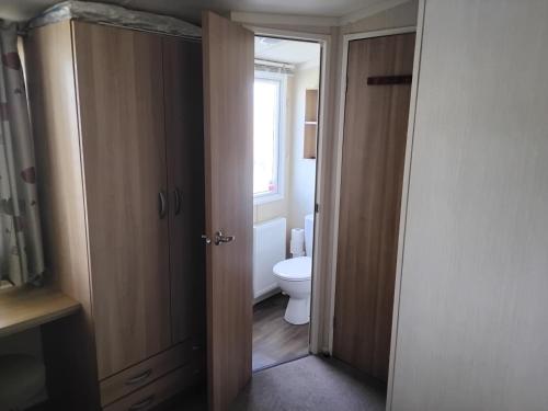 an open bathroom with a toilet and a window at The Bay View in Eyemouth
