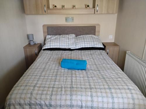 a bed with a blue box on top of it at The Bay View in Eyemouth
