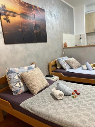 two beds with stuffed animals on them in a room at Apartman B&S Apatin in Apatin