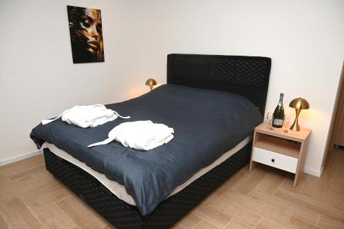 a bedroom with a bed with two white towels on it at Elysium3 in Banja Luka