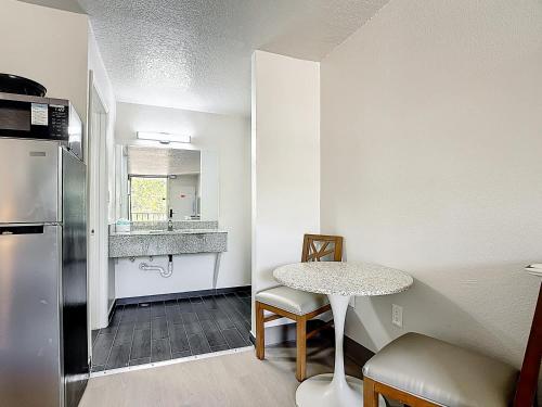 a small kitchen with a table and a refrigerator at Stayable Davenport in Davenport