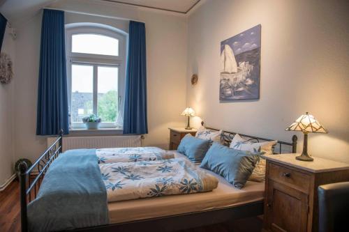 a bedroom with a bed and a window at Pension Onken in Bockhorn
