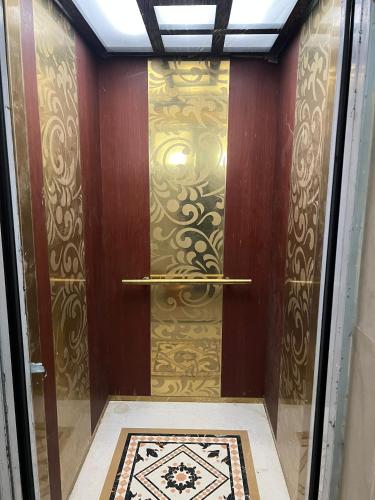a room with a door with a gold wall at Max Heights, 2 Captivating Bedrooms in Ikeja