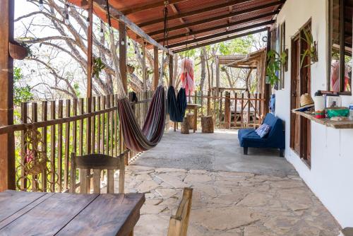 a porch with a hammock and a wooden fence at Casa Medusa in El Gigante