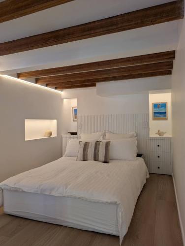 a white bedroom with a large white bed at Rivulet Nook in West Hobart