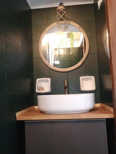 a bathroom with a sink and a mirror at Deli casa vacanze in Favignana