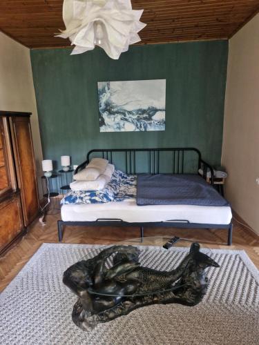 a bedroom with two beds and a statue on the floor at History Tornyos Apartman in Balatonfüred