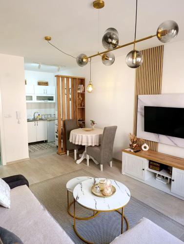 a living room with a couch and a table at Studio Arija -na par koraka od PARKA - Banja Koviljača in Banja Koviljača