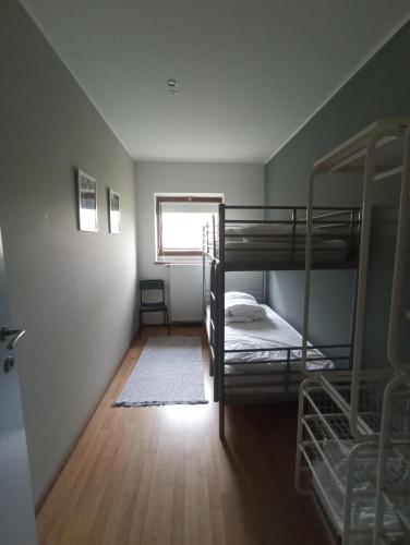 a room with two bunk beds and a window at Gîte de Thirifays in Chiny