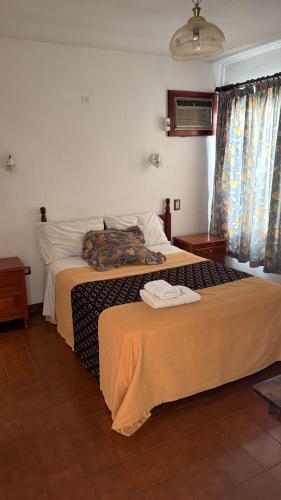a hotel room with two beds with towels on them at Hotel Pueblo Huarpe in San Luis