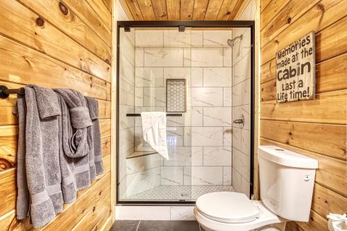 a bathroom with a shower and a toilet at Mountain View Hot Tub Cabin w Pool Table Romantic in Sevierville