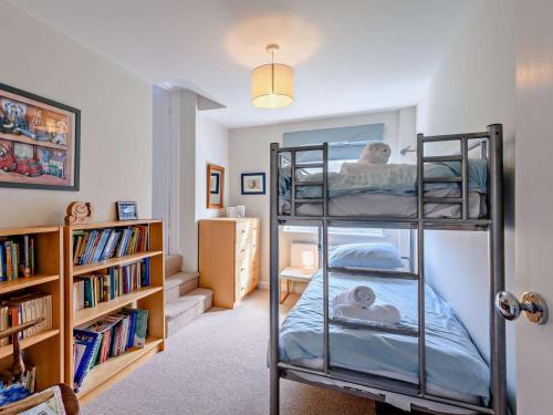 a room with two bunk beds and a book shelf at 4 Bed in Wareham oc-dc204 in East Stoke