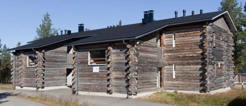 a log cabin with a black roof at Kelotie, Saariselkä, only week 24 available in Saariselka
