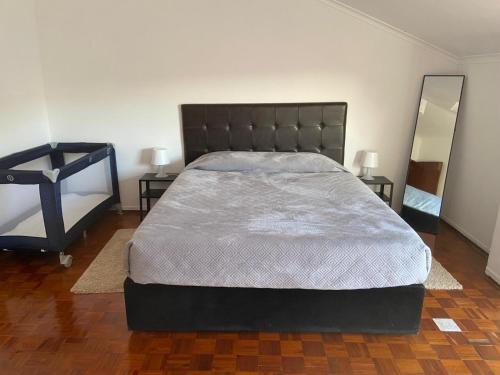 a large bed in a bedroom with two night stands at Lenny's house I in Agualva