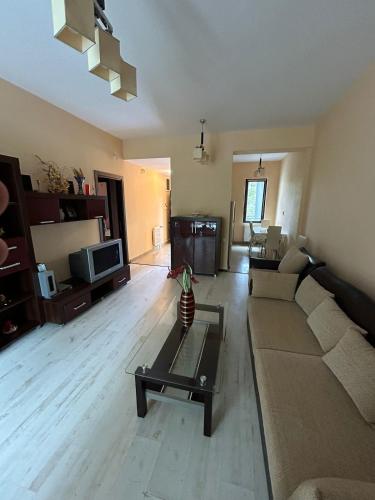a living room with a couch and a table at Bosco Dream Neptun-Olimp in Neptun