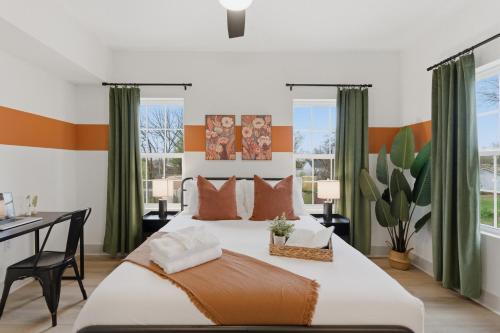 a bedroom with a large bed and a desk at The Lofts On Maney – Boutique Loft in Downtown Murfreesboro in Murfreesboro