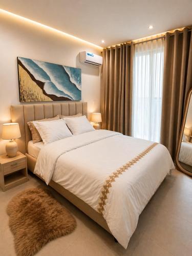 a bedroom with a large bed and a large window at Dakar Roi - Point E - Modern Studio - Central Location in Dakar
