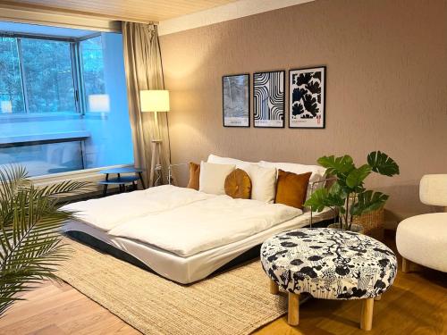 a bedroom with a white bed and a couch at Dock and Dwell City Appartment in Bern