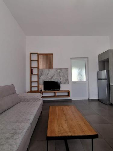a living room with a couch and a table at Holiday house in Laknas