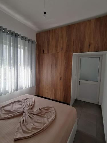 a bedroom with a large bed with a wooden wall at Holiday house in Laknas