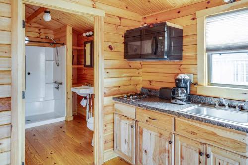 a kitchen with a sink and a microwave at Jellystone Park Gardiner in Gardiner