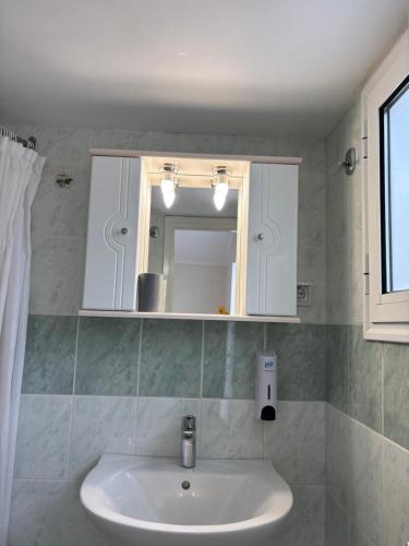 a bathroom with a sink and a mirror at Sea View Residence in Nea Kios
