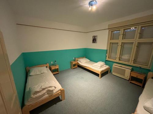 a room with two beds and two windows at Holiday house Mernye in Mernye