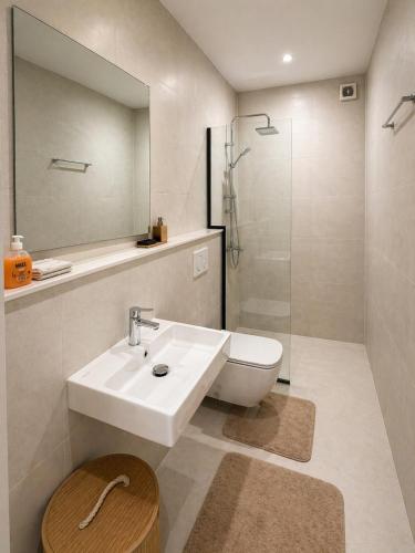 a bathroom with a sink and a toilet and a shower at Dakar Roi - Point E - Modern Studio - Central Location in Dakar