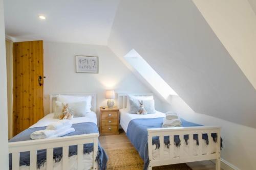 a bedroom with two beds and a staircase at 2 Bed in Hanworth oc-h32041 in Hanworth