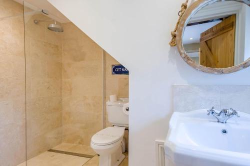 a bathroom with a toilet and a sink and a mirror at 2 Bed in Hanworth oc-h32041 in Hanworth