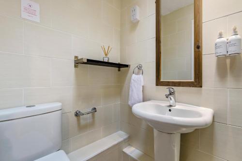 a white bathroom with a toilet and a sink at 2 Bed in Keswick oc-28377 in Braithwaite