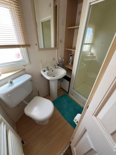 a bathroom with a toilet and a sink and a shower at 50 Seaview Ingoldmells in Ingoldmells