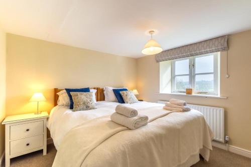 a bedroom with a large bed with towels on it at 3 Bed in Ripon oc-83728 in Healey