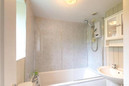 a bathroom with a tub and a sink and a toilet at 3 Bed in Ripon oc-83728 in Healey