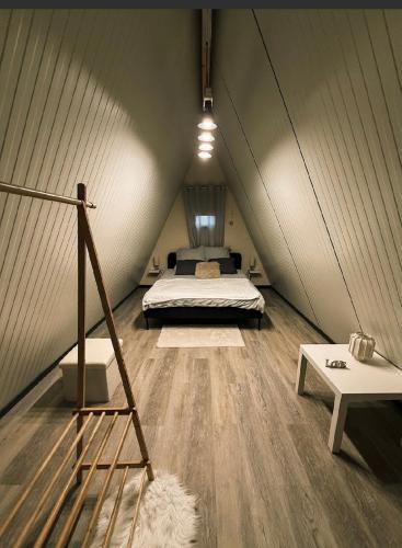 a bedroom with a bed in a tent at Lodge Lady Tipi 2 avec jacuzzi et piscine in Saint-Utin