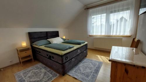 a bedroom with a bed with blue pillows on it at Violetta Vendégház in Keszthely